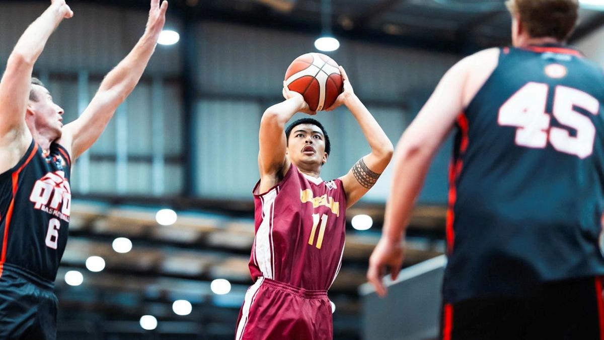 A basketballer jumps to shoot a shot during a game.