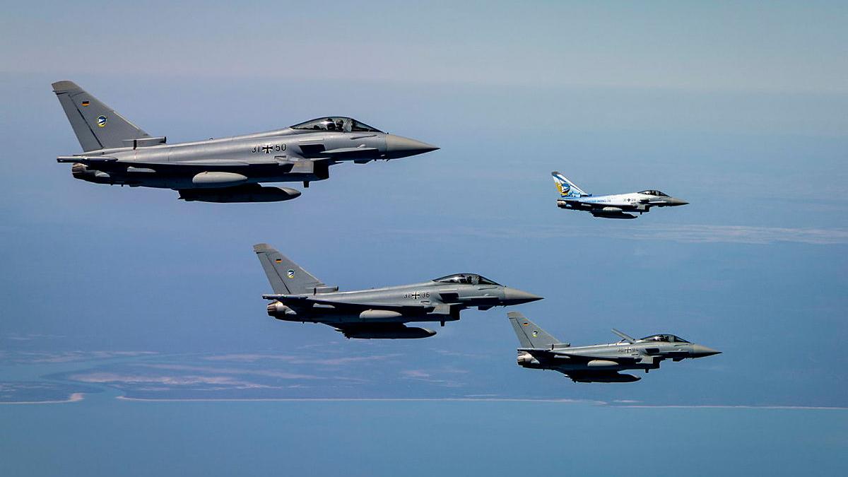 Four aircraft fly in formation.
