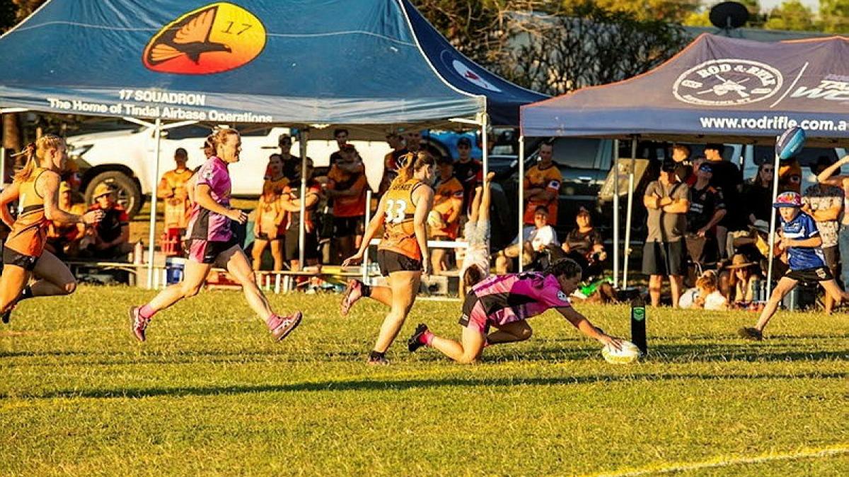 Two women's teams verse in a game of rugby league.