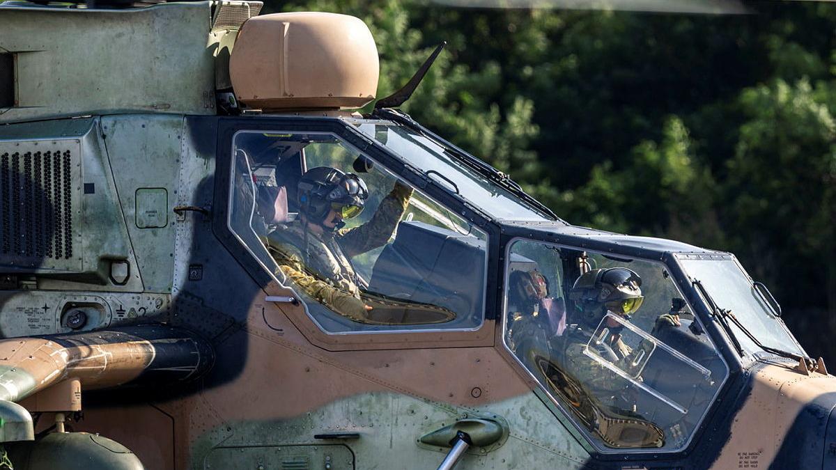 Two Australian Army helicopter pilots prepare for take-off during an international training exercise.
