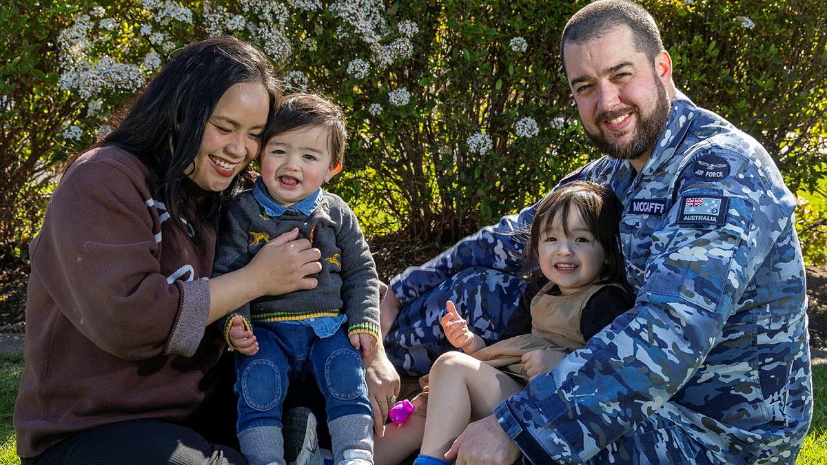 A military man with his partner and two children, one girl and one boy.