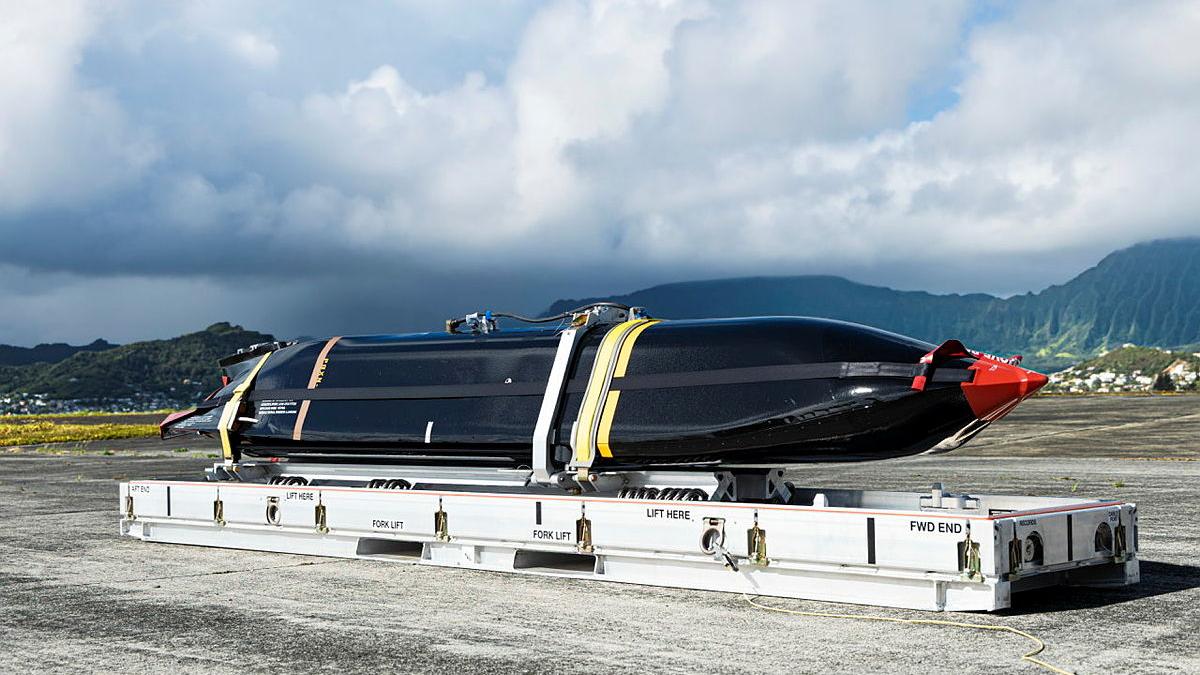 A missile is strapped down on the tarmac.