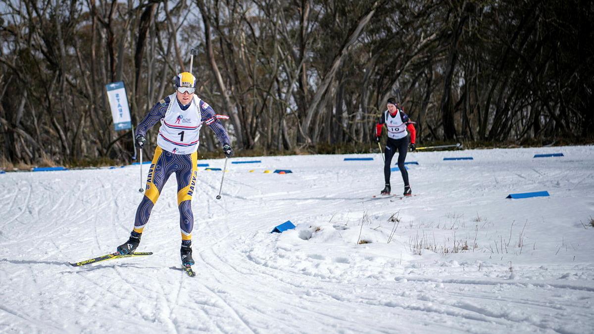 A Navy skier takes the lead over his opponent in a race.