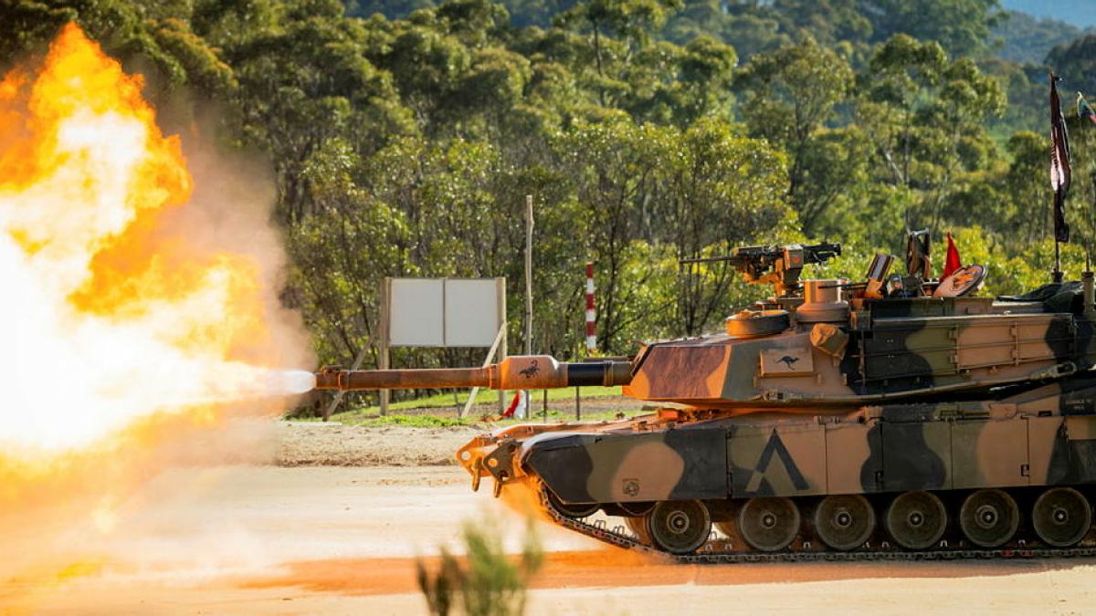 A tank fires and a large flame is seen coming out of the turret.