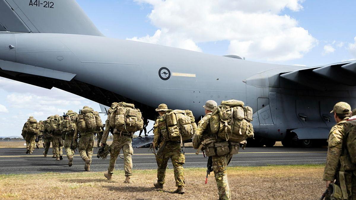 Australian Army soldiers disembark off a Royal Australian Air Force plane.