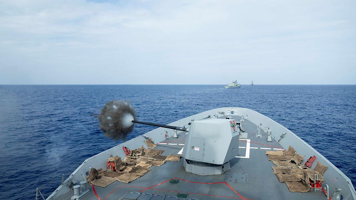 The bow of a Sydney Navy war ship blasts its five - inch gun during a training exercise.