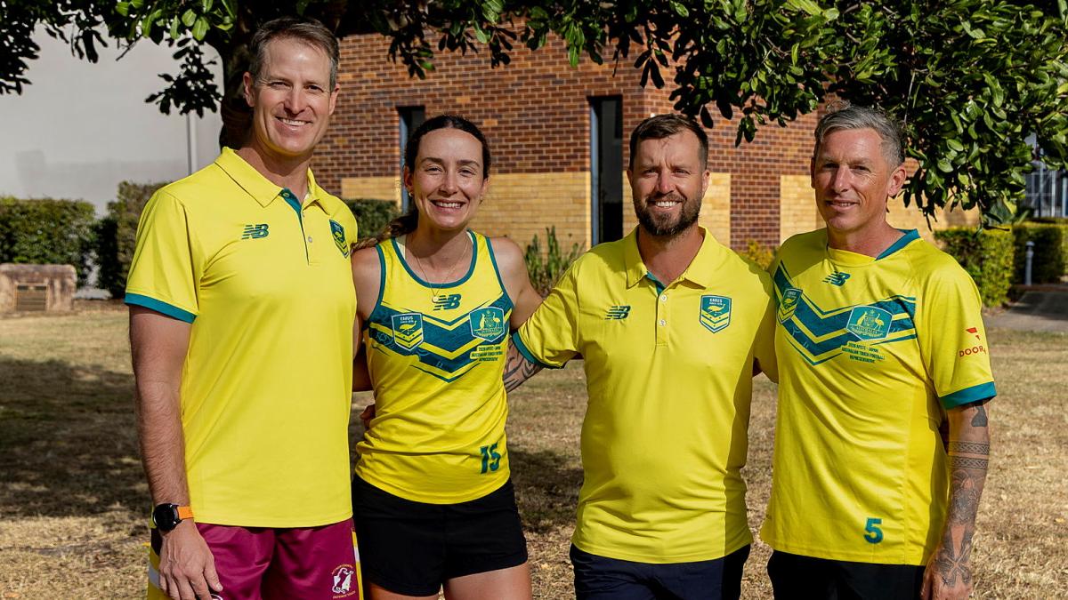 Four people in yellow and green sports outfits stand together outdoors.