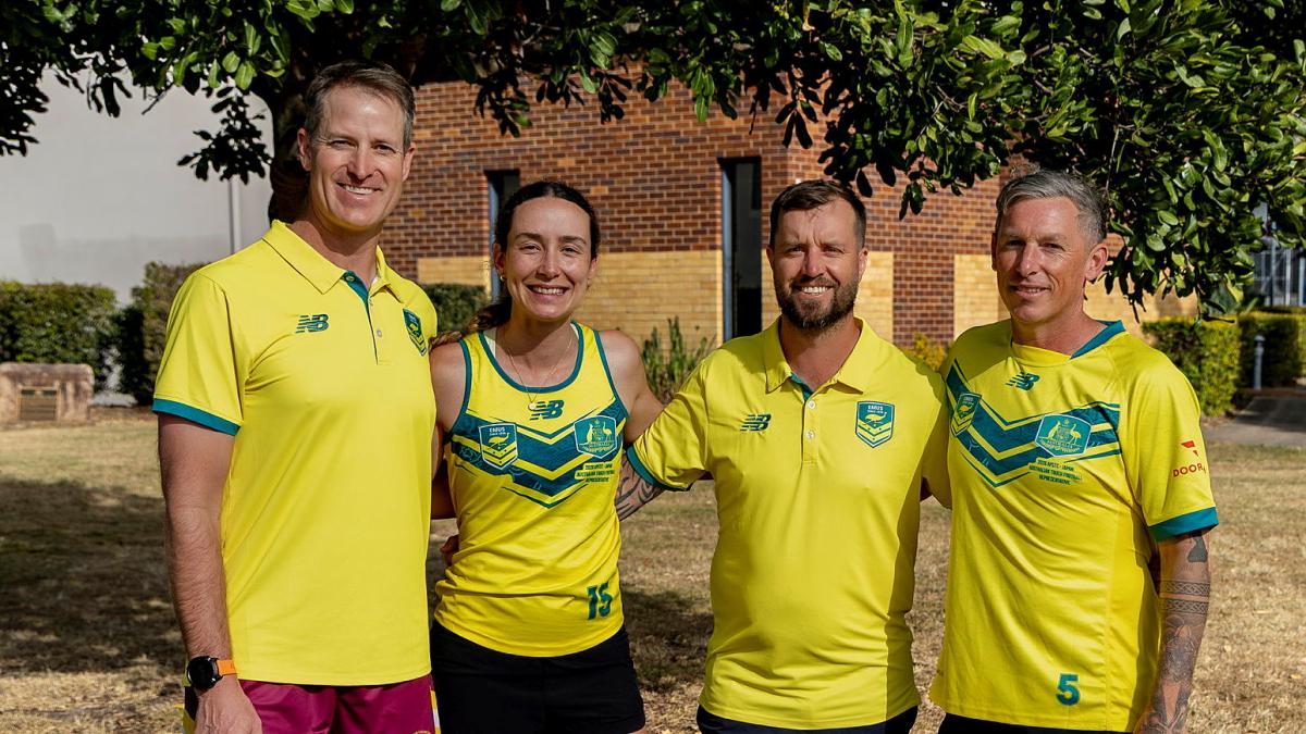 Four people in yellow and green sports outfits stand together outdoors.