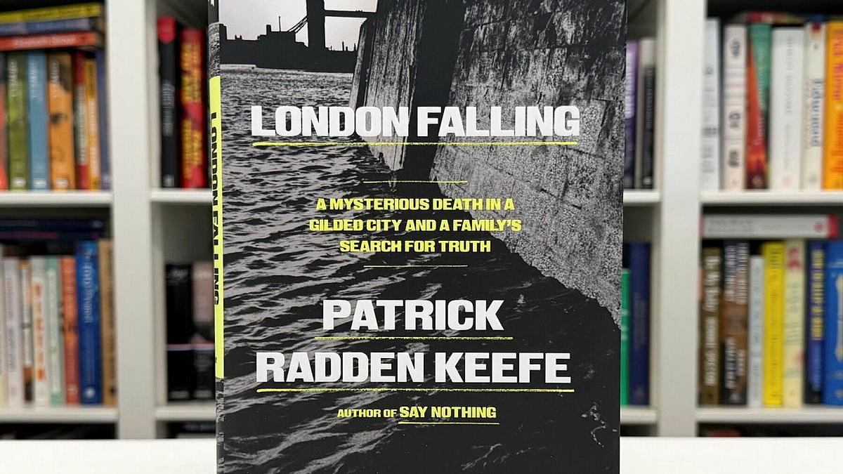 The book London Falling by Patrick Radden Keefe stands upright in front of a shelf of other books.