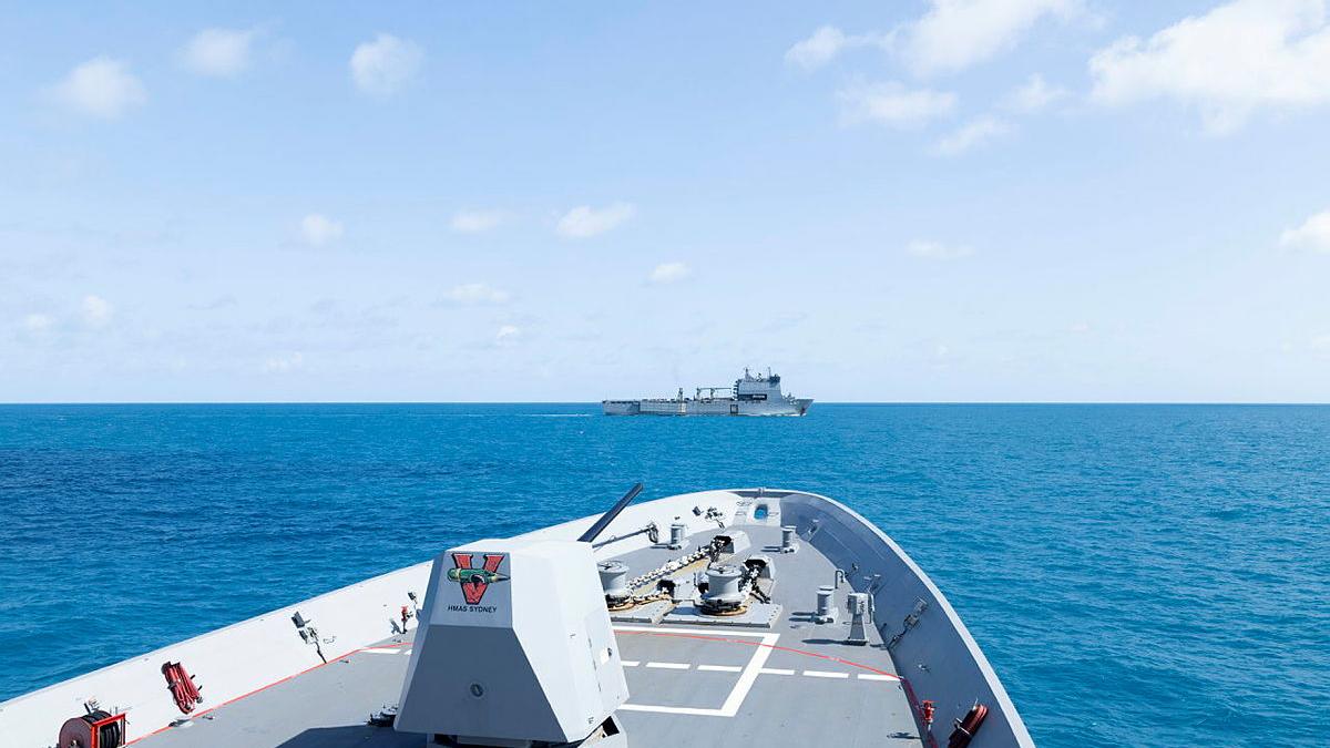 The bow of one ship points towards another ship in the distance.