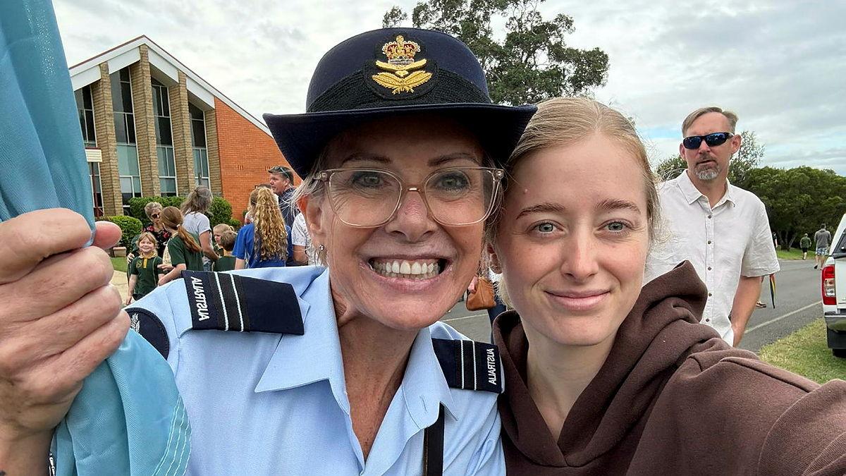 A military woman and a young civilian girl.