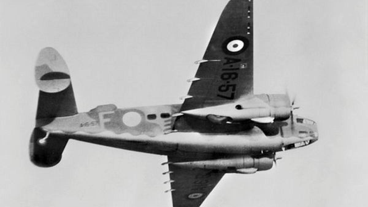 Old military aircraft flies through the sky